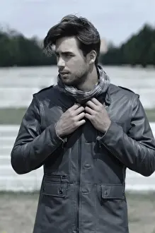Contemplates Prints: Young man wearing a leather jacket in front of an open staircase, portrait