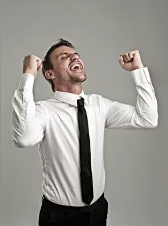 Young man wearing a shirt and a tie cheering, success, victory pose