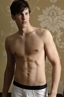 Light Prints: Young man wearing underwear standing in front of nostalgic wallpaper