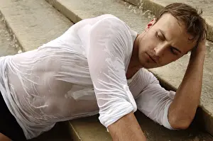 Introspection Prints: Young man wearing a wet shirt, lying on stairs