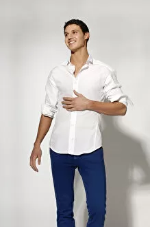 30 39 Years Collection: Young man in white shirt and blue jeans in movement