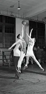 Prints of (Original Caption). VT-Photo shows four young men playing basketball, University of Vermont. Models: H. Paxman, R. Boudreau, G. Shea and G. Abair, Ca. 1950s Hoops Through Time: A Visual Journey of Basketball History: Four Young Men Playing Basketball/Univ