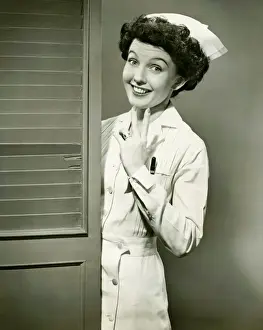 Permed Hair Prints: Young nurse smiling by open door, (B&W)