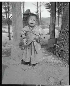 Young Orphaned Korean Outdoors Without Shoes