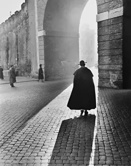 Vestments Prints: Young Priest Walks Toward an Arch
