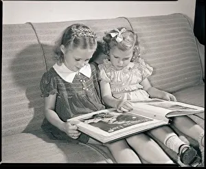 Young Sisters Reading