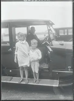 Young Socialites next to Chauffeured Automobile