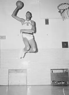 Young Wilt Chamberlain Going up for a Jump