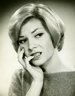 Young woman with anxious expression, in studio, (B&W), (Portrait)