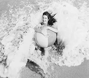 Refreshing Prints: Young Woman with Beach Ball in Surf