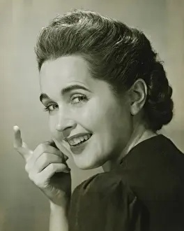 Permed Hair Prints: Young woman beckoning, (B&W), portrait