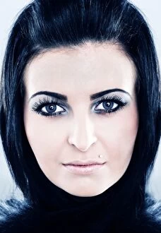 Young woman with black hair, blue eyes and fake eyelashes