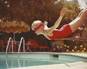 Retrofile Gallery: Young woman with blindfold balancing on diving board