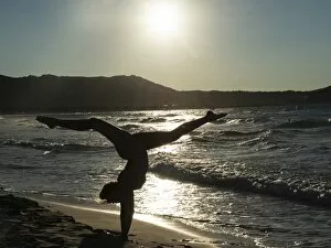 Images Dated 3rd September 2014: Young woman doing gymnastics on the beach, backlight, Corsica, France