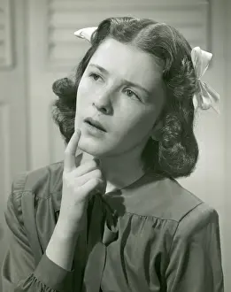Young woman with hand on chin