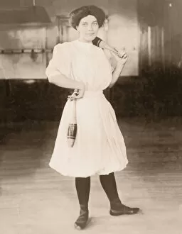 Young woman holding exercise pins (B&W sepia tone)