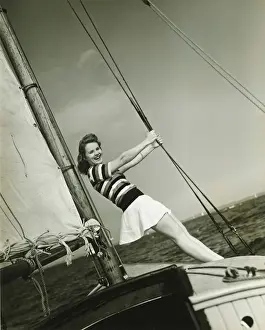 Weekend Activities Prints: Young woman holding rigging on yacht, (B&W)