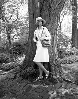 1960s Fashion Gallery: Young woman leaning by tree, (B&W)