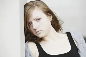 Introspection Prints: Young woman leaning against a wall, portrait