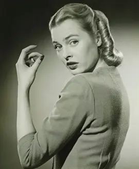 Blonde Hair Prints: Young woman looking over shoulder, (B&W), portrait