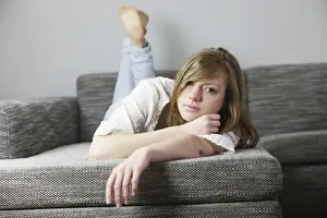 Lying Down Prints: Young woman lying on the couch