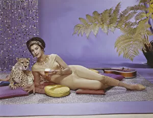 Young woman lying on cushion with leopard