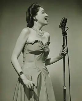 Earring Prints: Young woman at microphone, singing, (B&W)