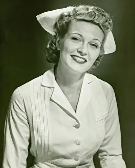 Blonde Hair Prints: Young woman in nurse clothing smiling, (B&W)