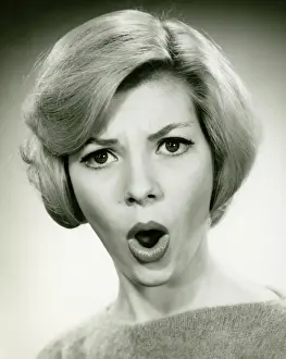 Blonde Hair Prints: Young woman with open mouth in studio, (B&W), (Portrait)