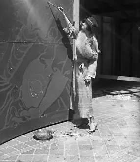 Collar Prints: Young woman painting mural