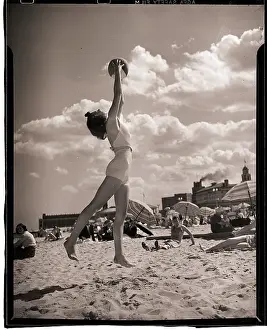 Young Woman Playing Ball On Beach
