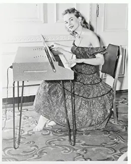 Young Woman Playing Electric Piano