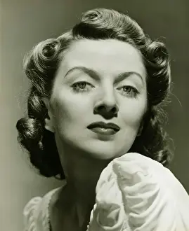 Permed Hair Prints: Young woman posing in studio, (B&W), portrait, close-up