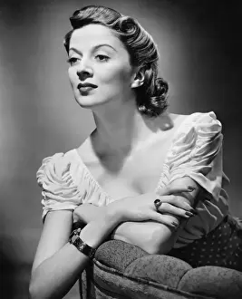 Permed Hair Prints: Young woman posing in studio, (B&W), portrait