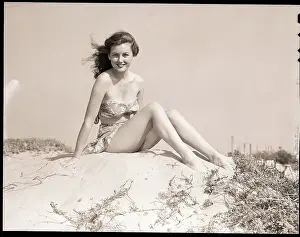 Young Woman Seated on Sand Dune