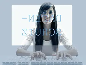 Typing Prints: Young woman seen through the display of a computer while using the keyboard