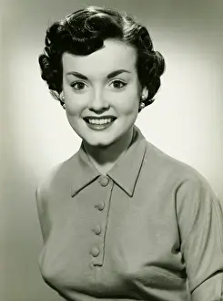 Earring Prints: Young woman with short hair smiling, (B&W), portrait