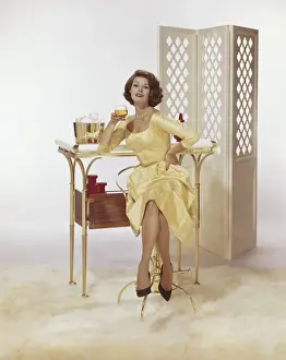 Beer Glass Prints: Young woman sitting on chair holding beer glass with Screen Partition in background