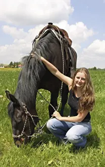 Bavarian Prints: Young woman sitting next to her horse, Bavaria, Germany, Europe