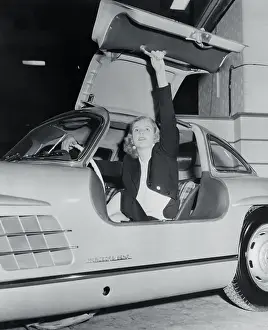 Prints of (Original Caption). Lovely Geraldine Butler demonstrates the folding top on the Mercedes-Benz 300SL as the London Auto Show at Earls Court opens Vintage Car Collection Prints: Young Woman Sitting in Sports Car