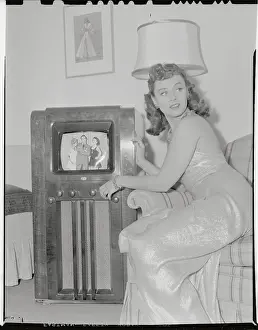 Young Woman Sitting Next to Television