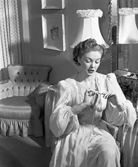 Blonde Hair Prints: Young woman sitting at vanity table, (B&W), elevated view