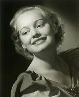 Hair Back Prints: Young woman smiling, close-up, studio shot