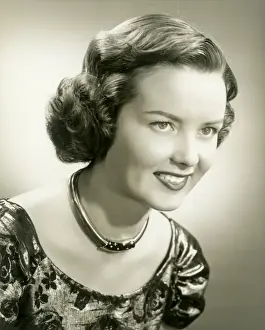 Young woman smiling, close-up, studio shot