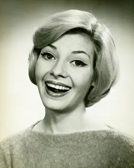 Raised Eyebrow Prints: Young woman smiling, posing in studio, (B&W), (Portrait)
