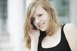 Femininity Prints: Young woman speaking on her mobile phone, smiling