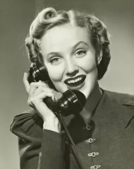 Images Dated 5th May 2006: Young woman using phone, smiling, (B&W), portrait