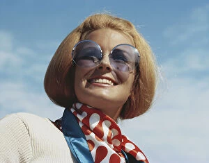 Casual Collection: Young woman wearing sunglasses, smiling, close-up