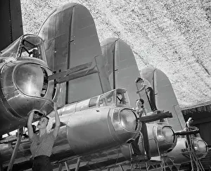 Long Beach Prints: Young Woman Working on Airplane Part