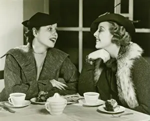 Gossiping Prints: Two young women chatting, having coffee and cake, (B&W)